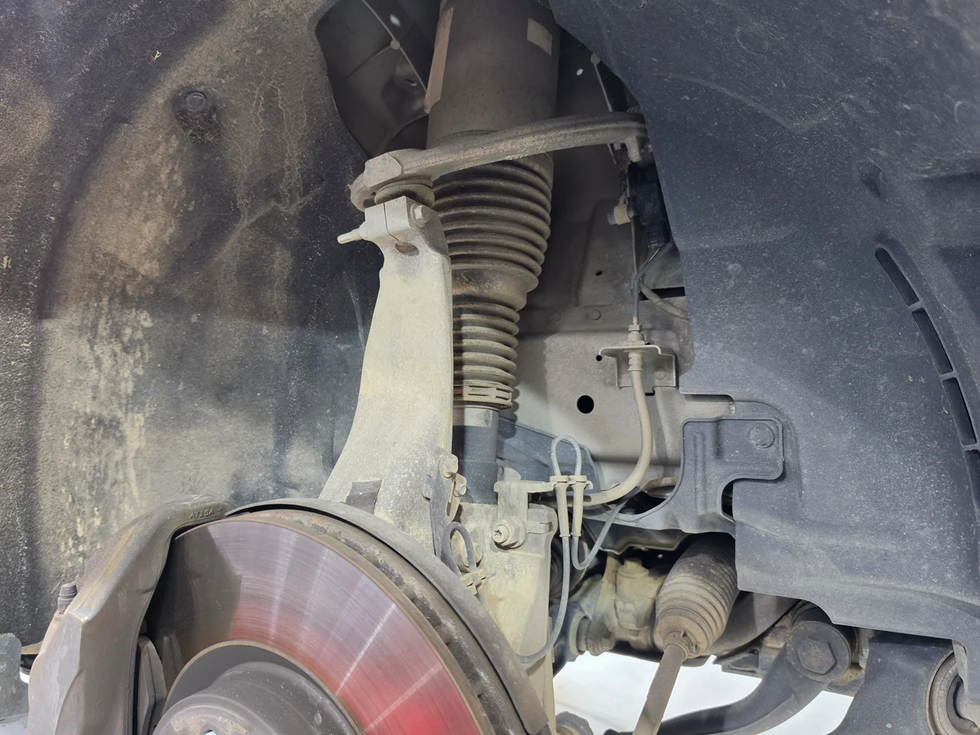 Accessing the passenger-side air strut