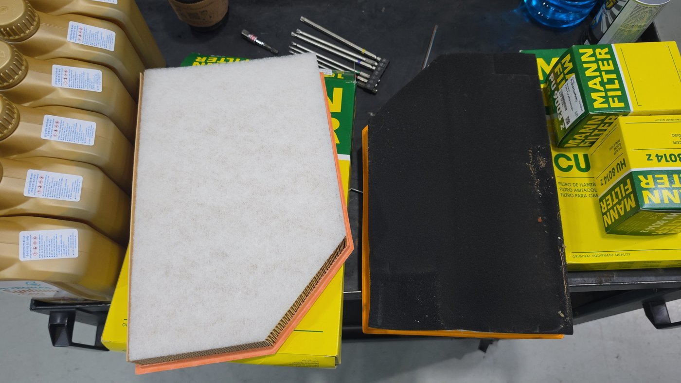 Old air filter next to the new replacement filter.