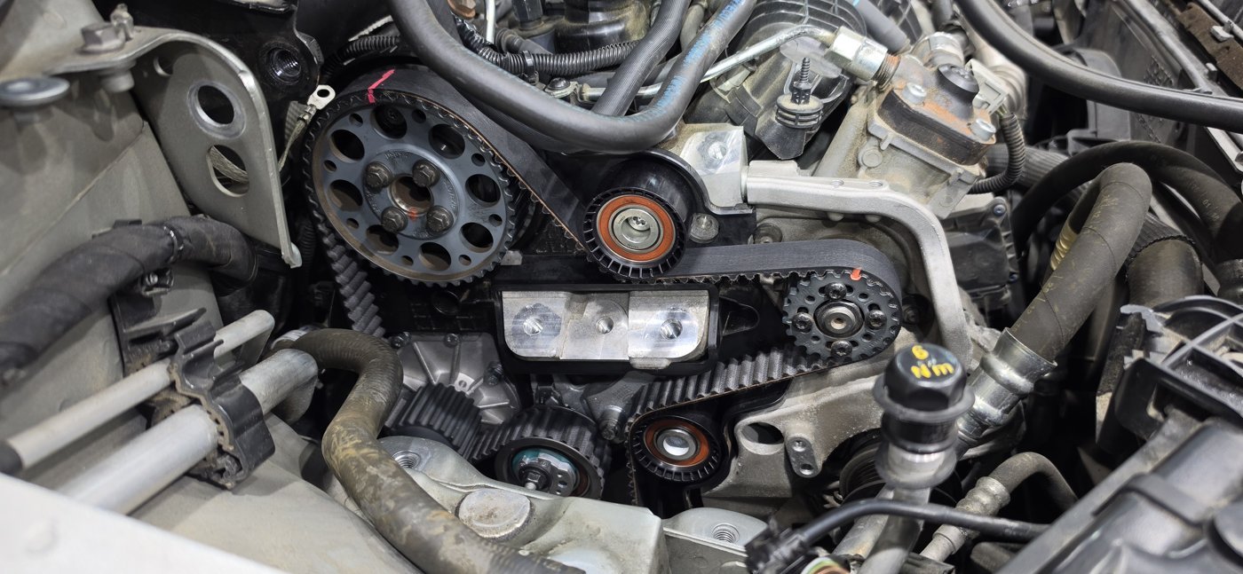 Timing belt and pulley assembly behind the cover.
