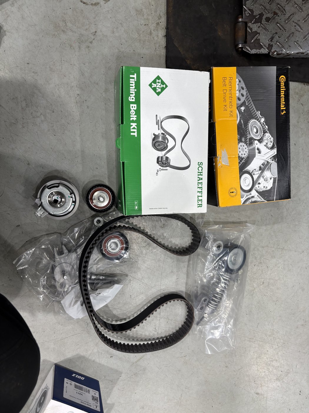 Timing belt kit parts from the replacement, including the belt and rollers.
