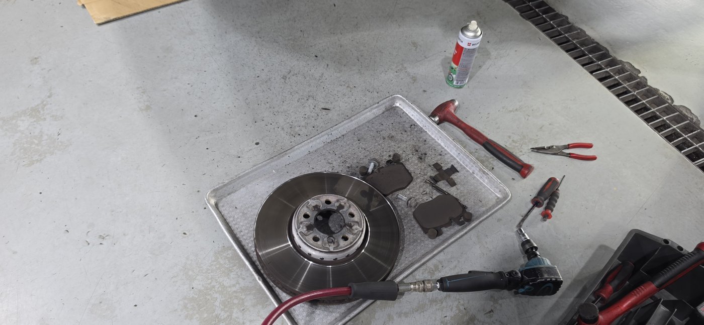 Front brake disc and pads after removal.