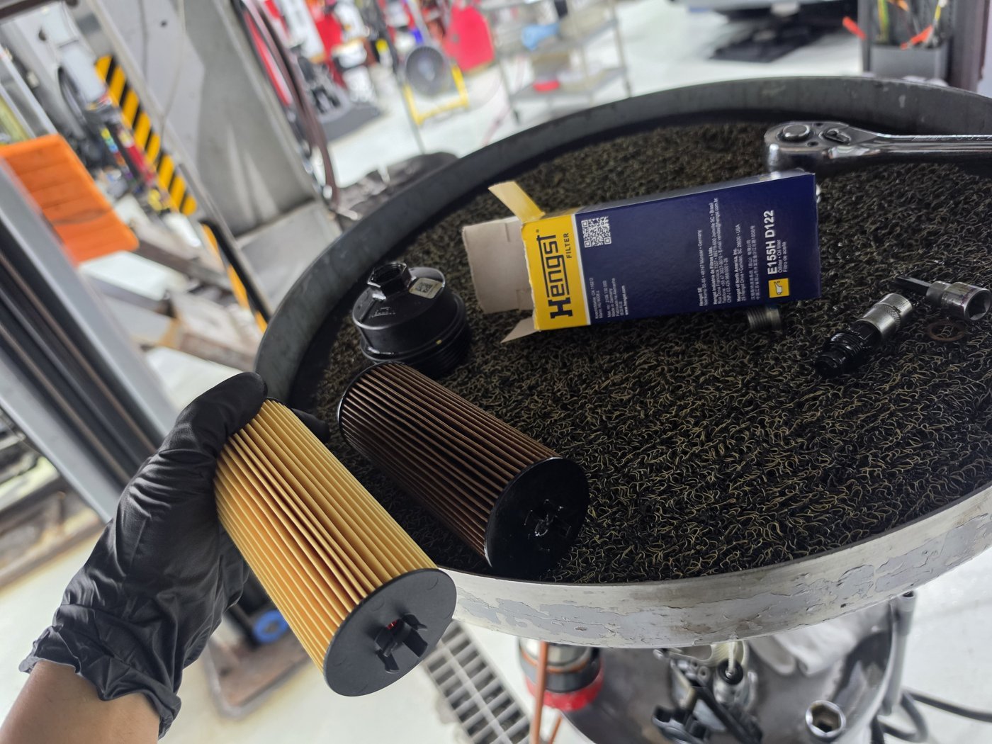 Comparing the removed oil filter with the new one to be installed.