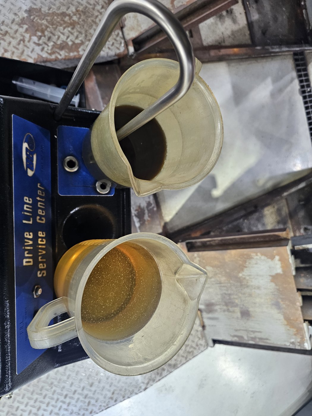 Color comparison of oil in measuring containers