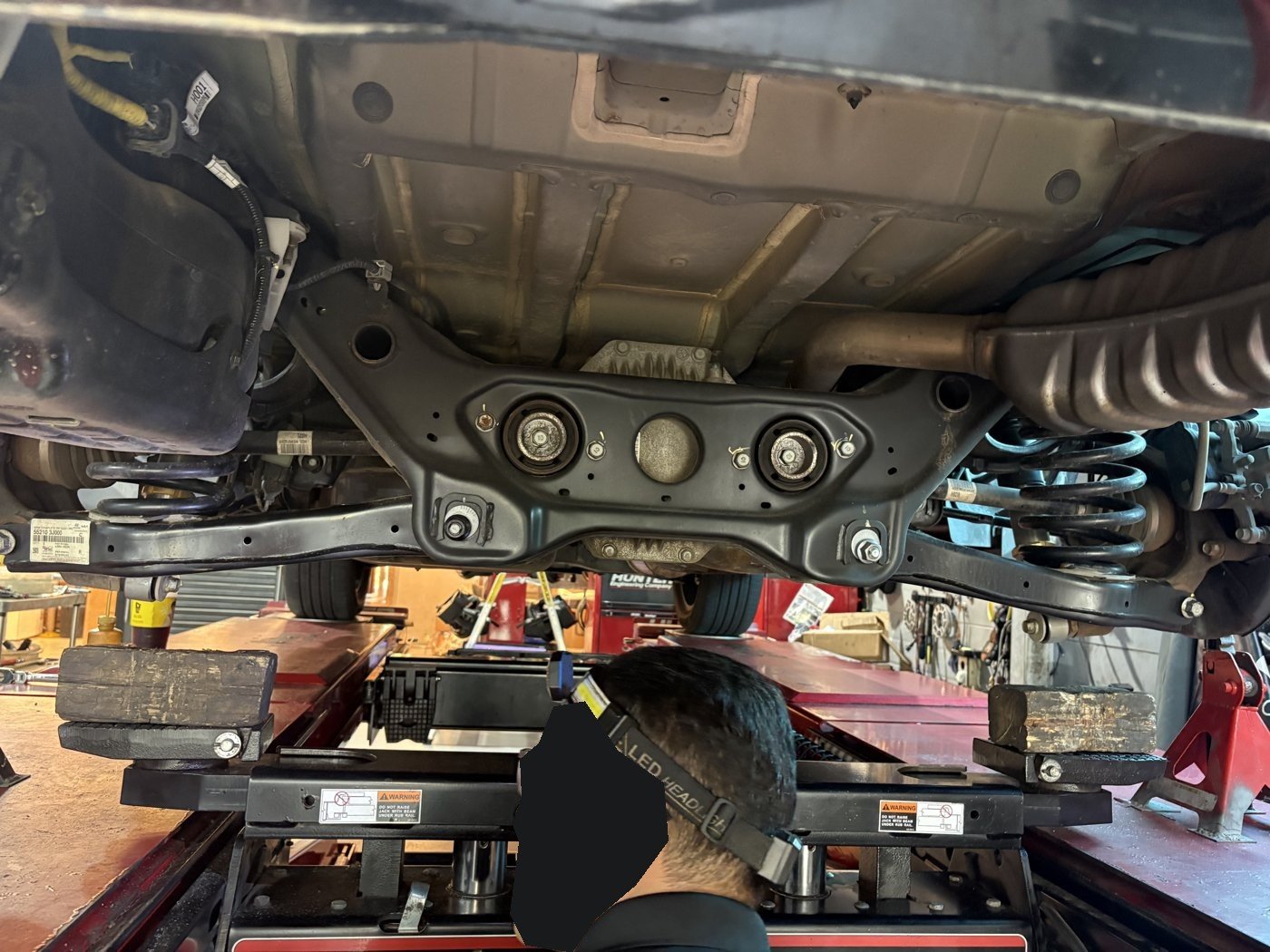 Tightening a suspension bushing mount.