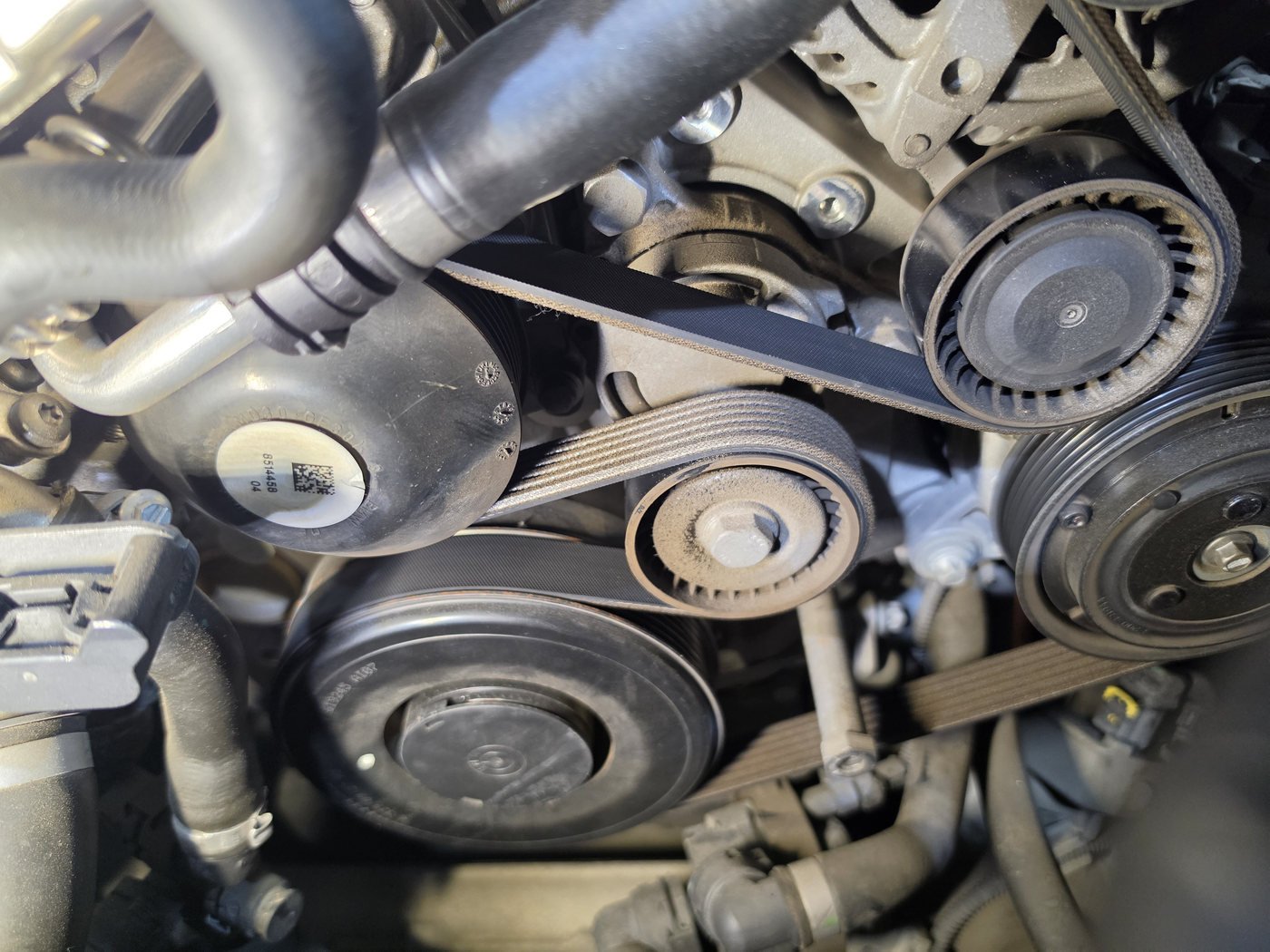 Belt and pulleys that drive the compressor