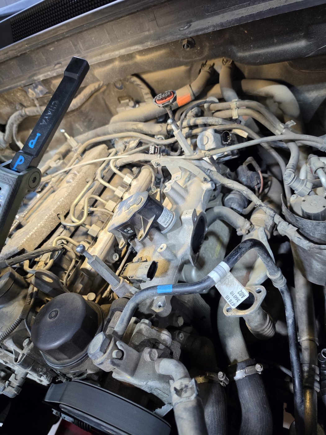 Accessing the intake manifold while disconnecting the surrounding connections.