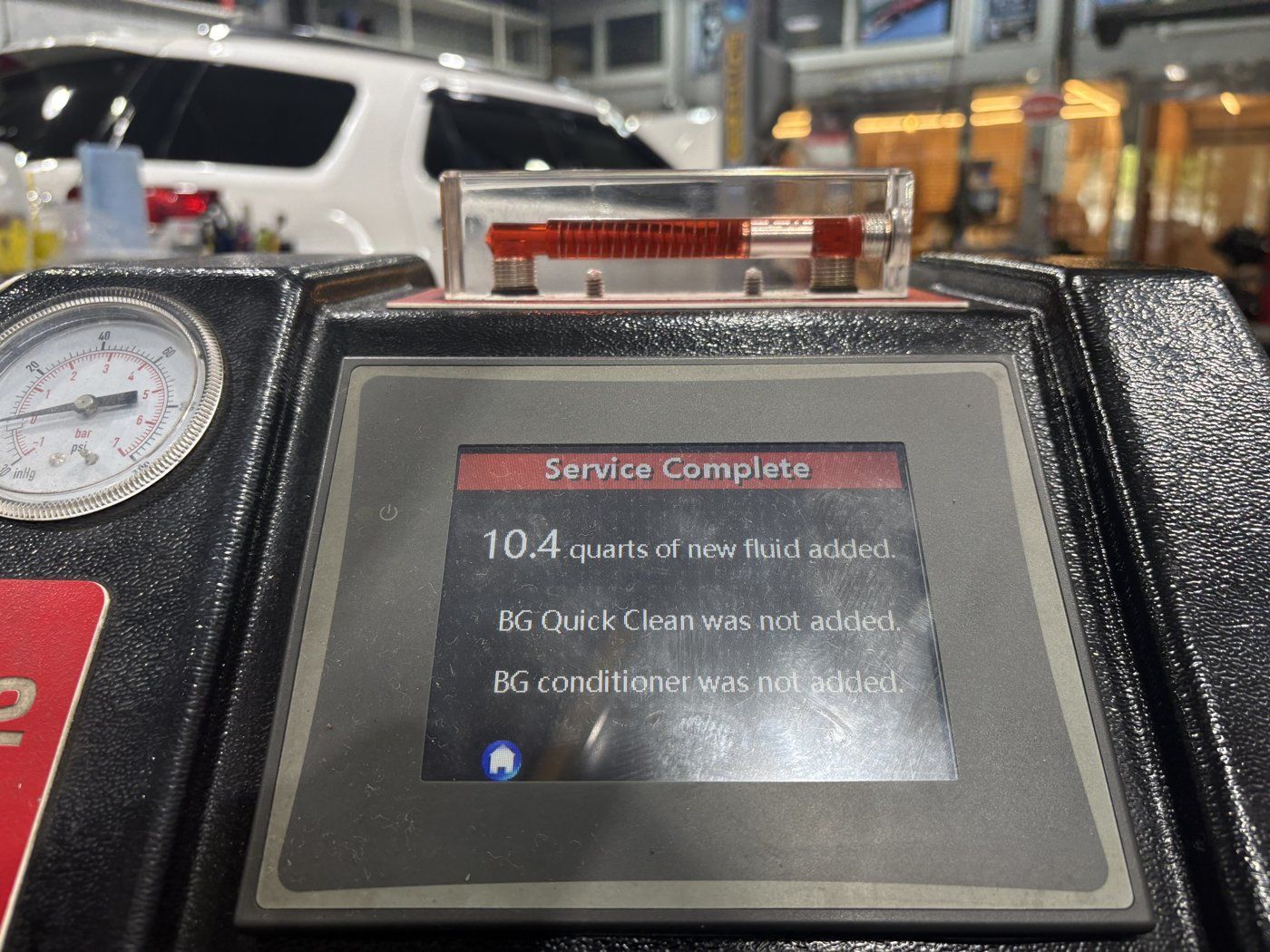Exchange machine completion screen showing 10.4 quarts of new fluid supplied.