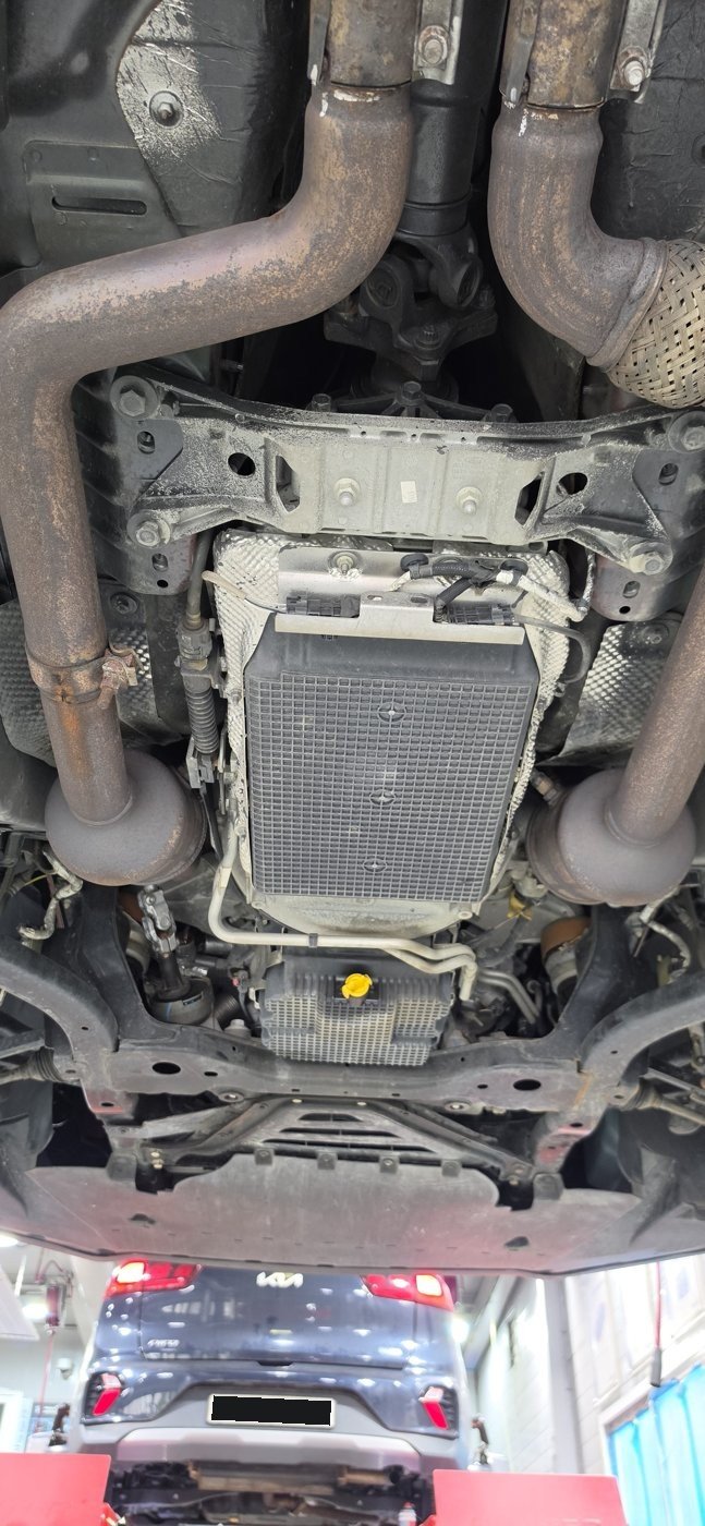 Accessing the transmission oil pan from underneath.
