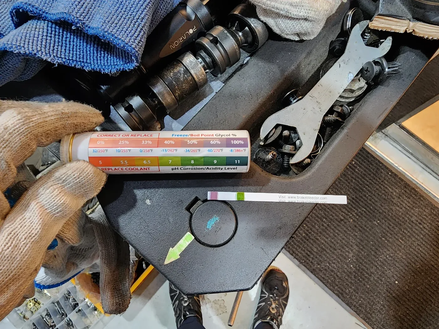Coolant test strip and comparison chart, used alongside the visual inspection.