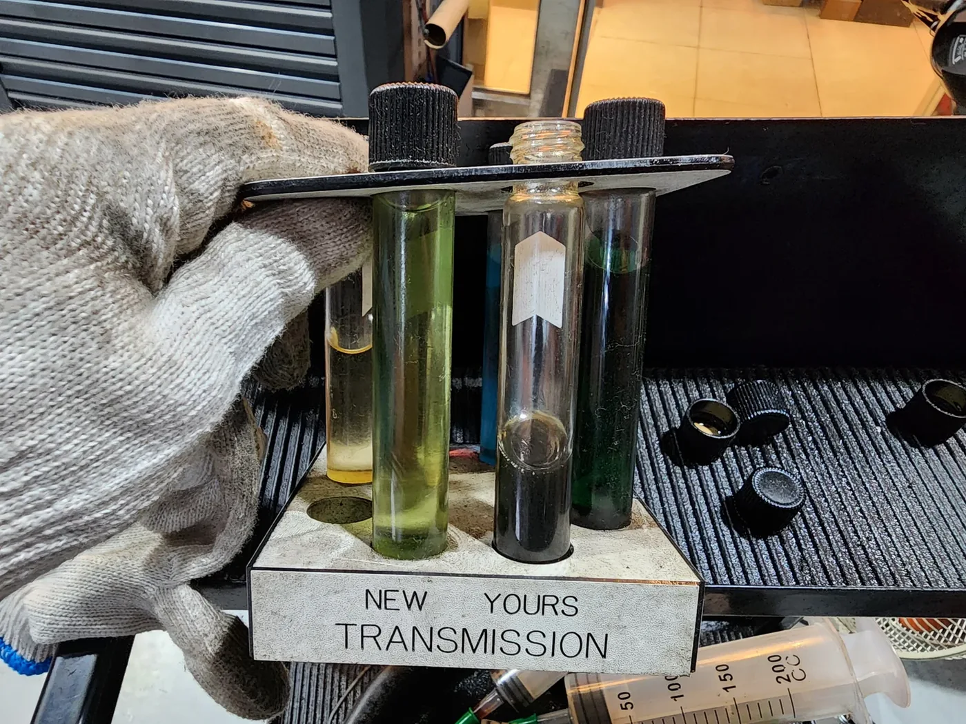 Transmission fluid comparison: NEW is fresh fluid; YOURS is the sample from the car.