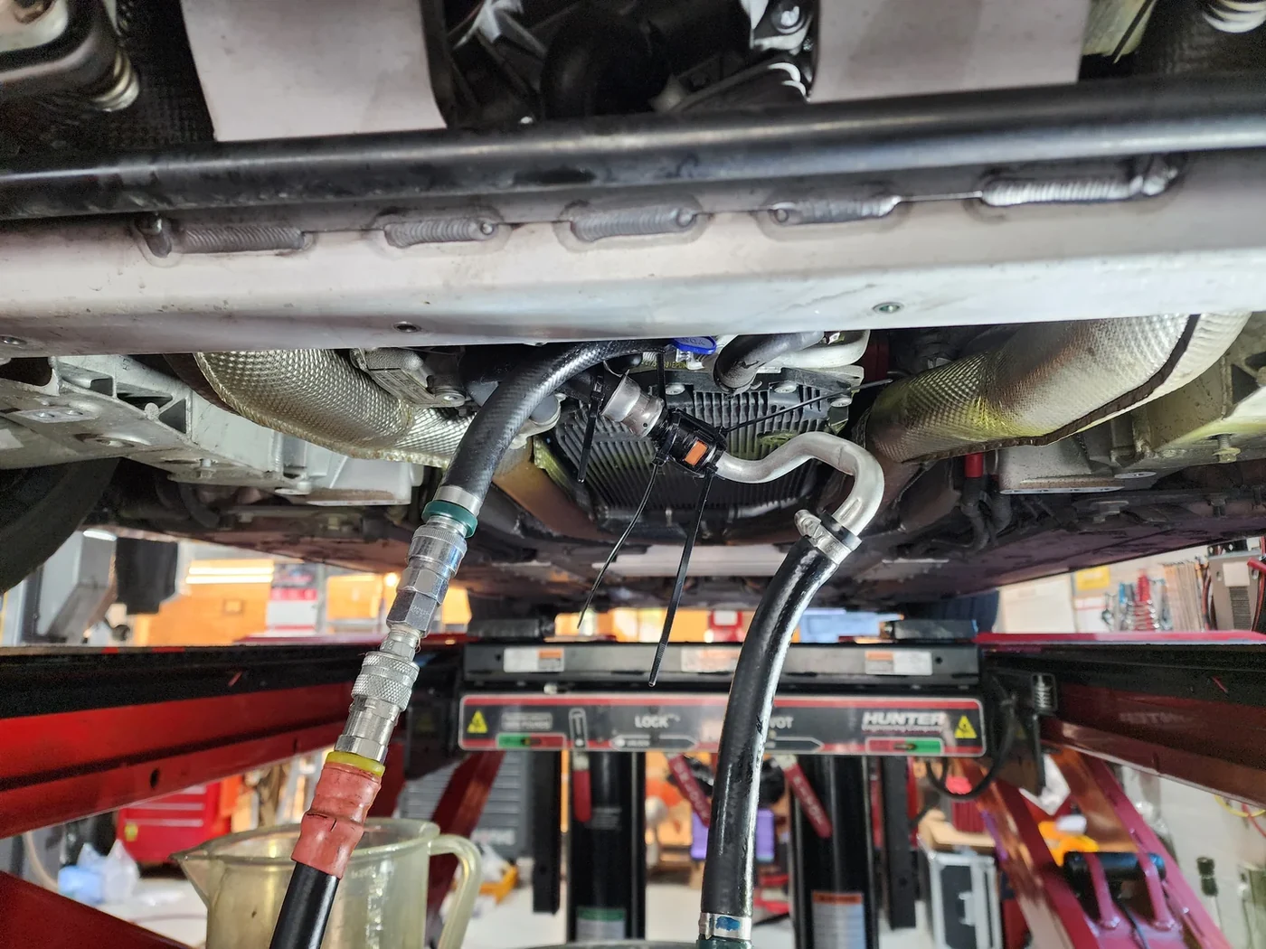 Hoses connected to the cooler line during transmission fluid replacement.