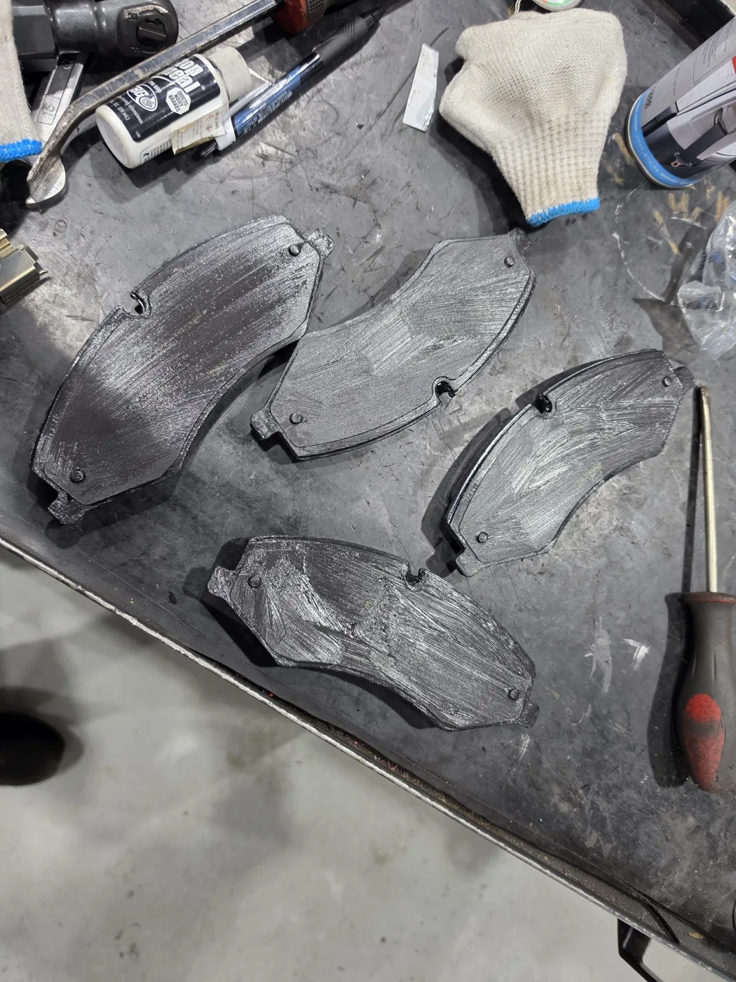 Dedicated brake grease applied to the pad backing and contact points