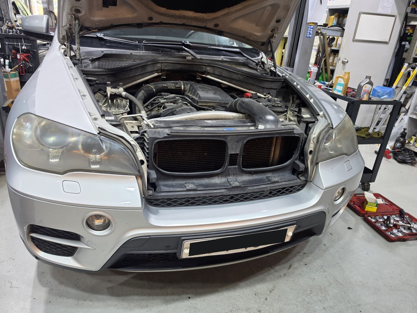 Engine bay of the 2010 BMW X5 E70 35i with the hood open