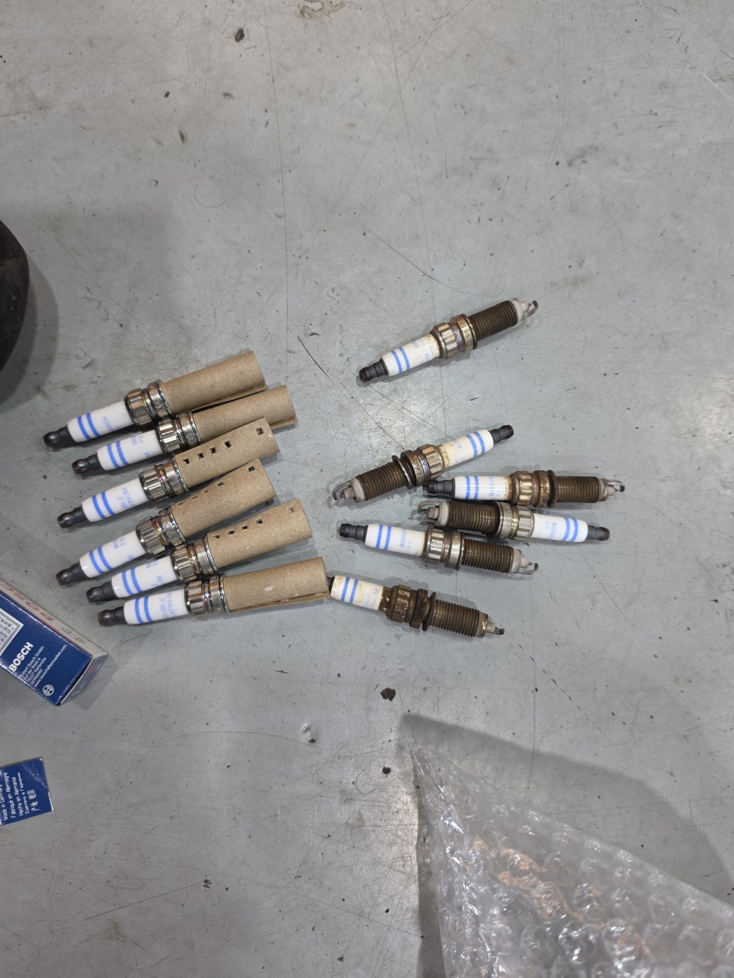 Removed spark plug compared against a new one
