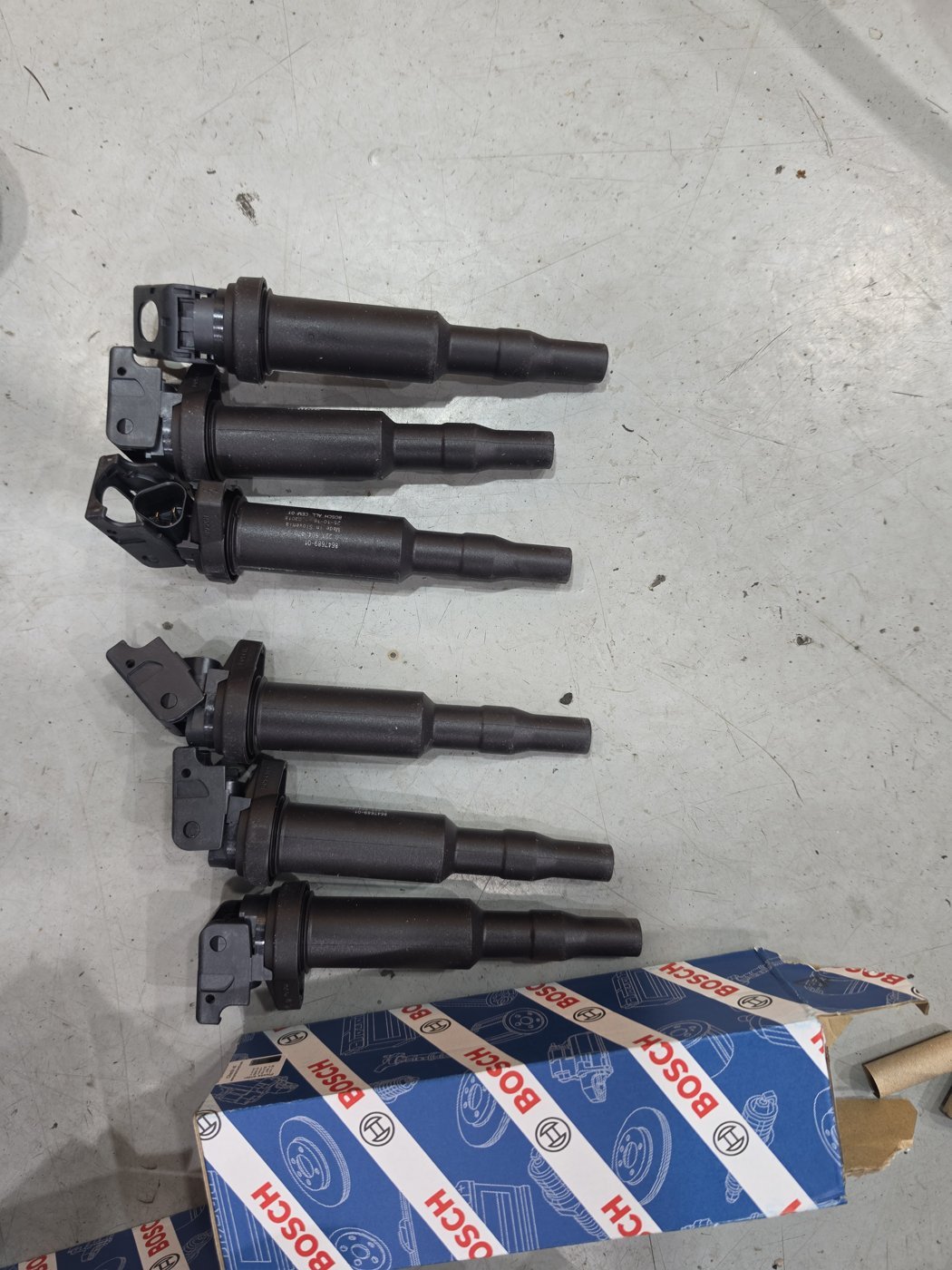 Six removed coils and boxes of new BOSCH coils