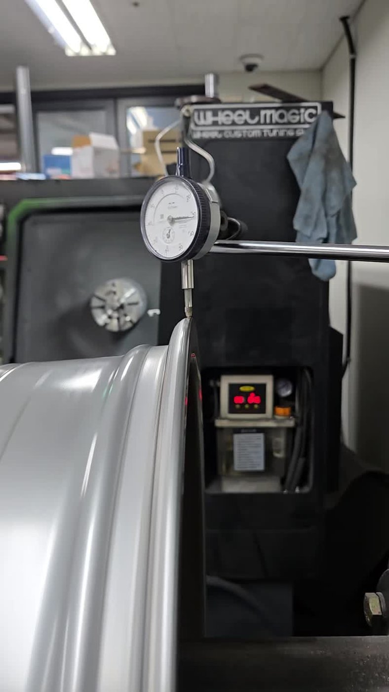 Measuring the wheel's shape with a dial gauge against the rim