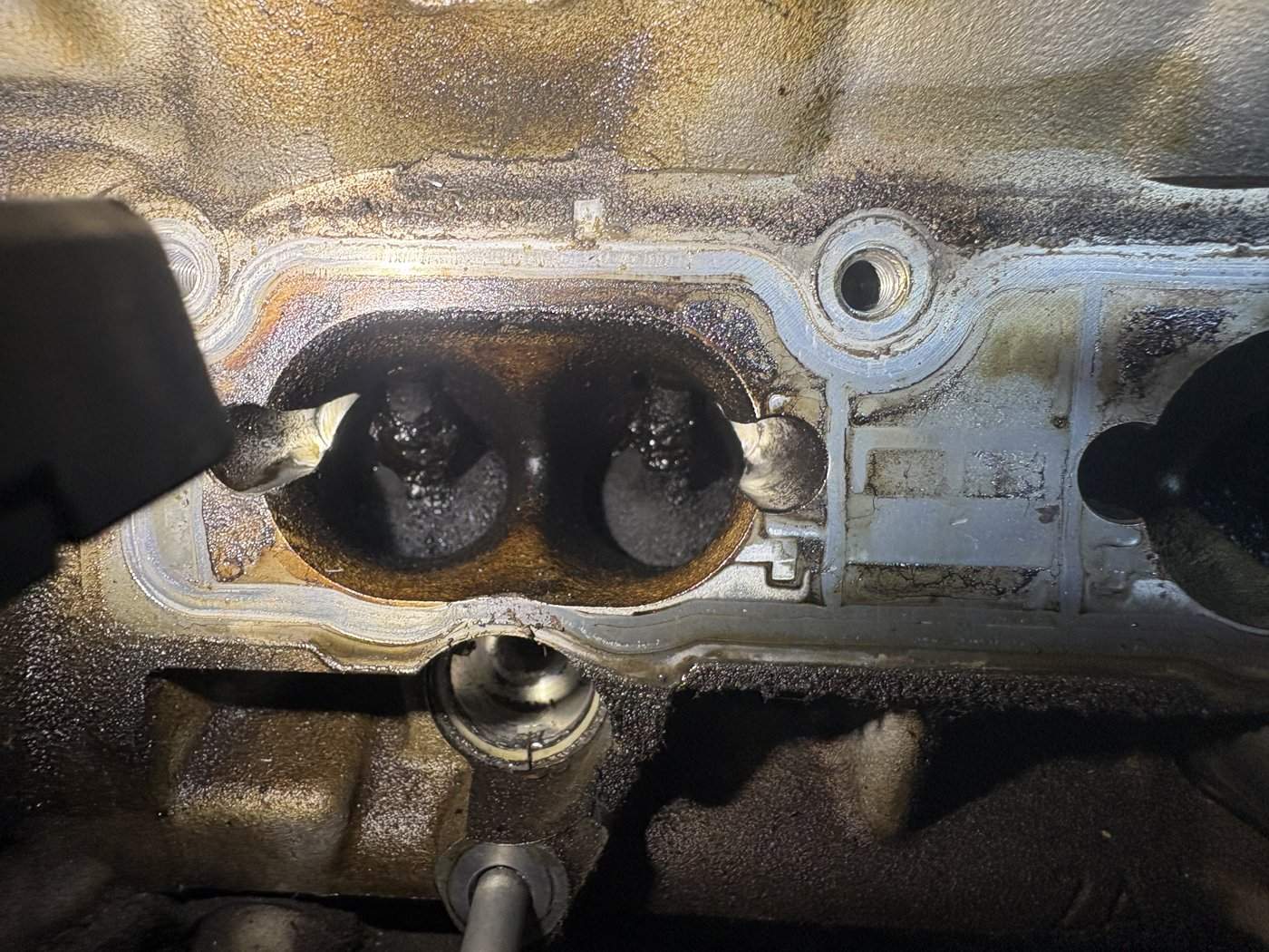 Thick black carbon built up as far as the valves