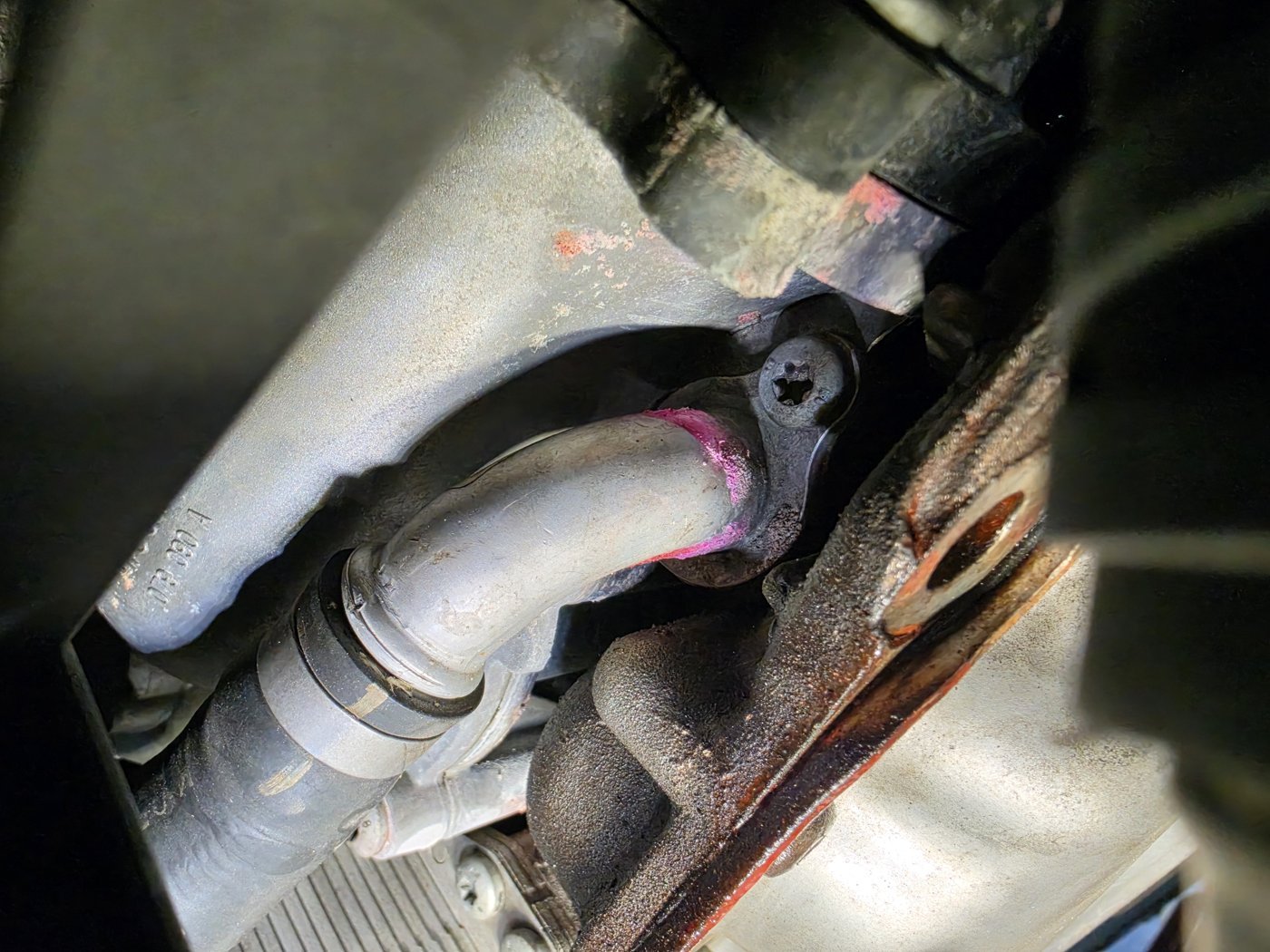 Traces at a pipe joint under the engine. Where fluid collects may not be where the leak starts.
