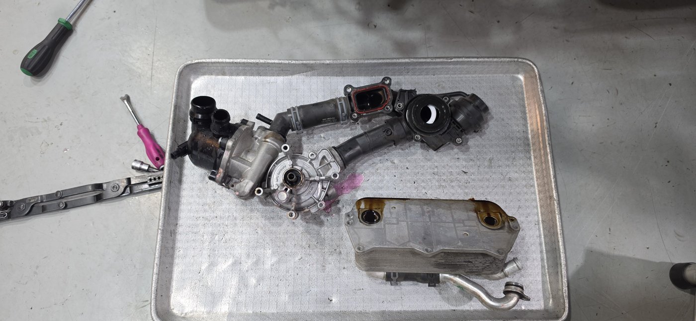 Housing and pipe connection parts removed from the front of the engine