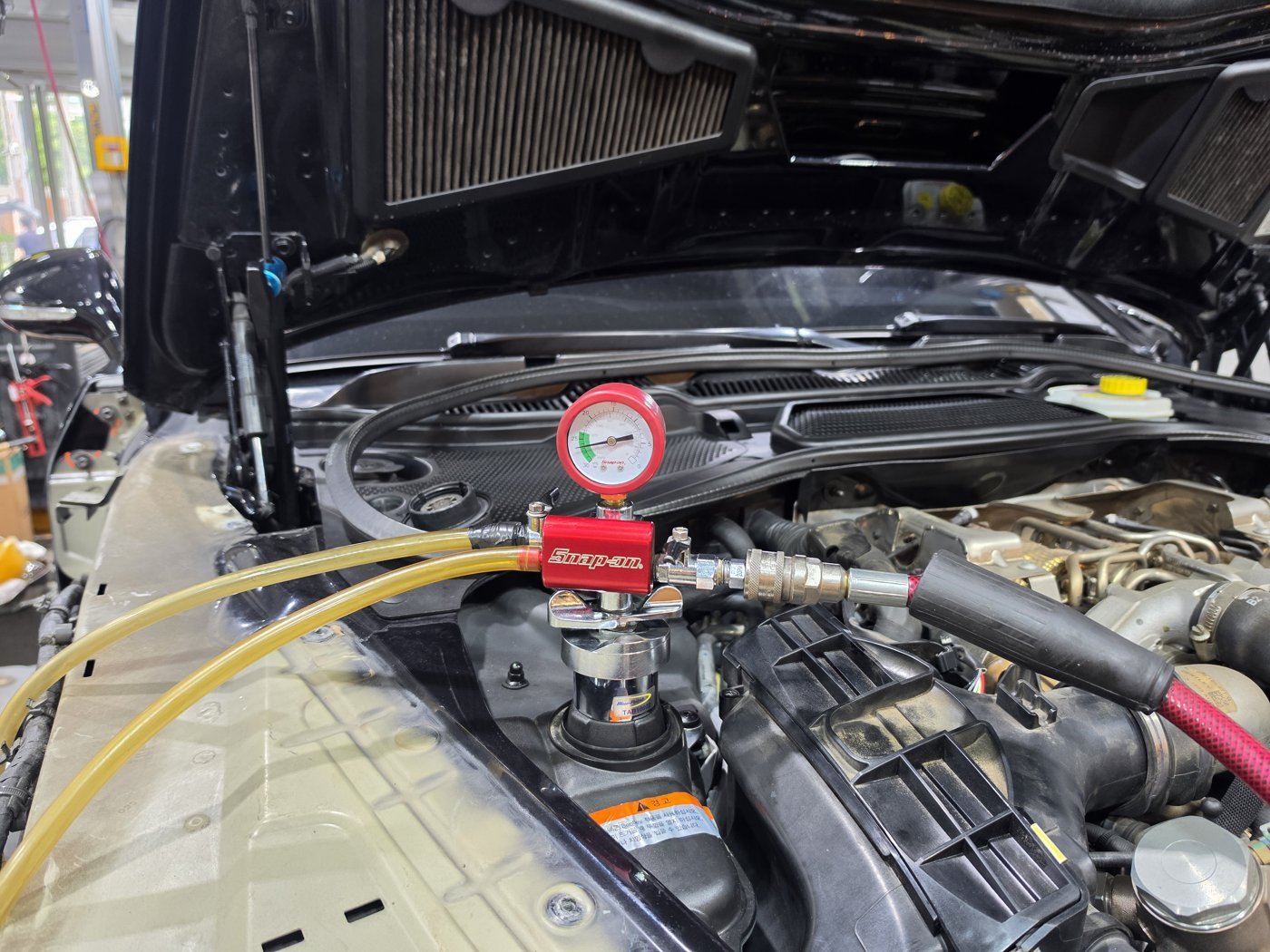 Gauge and hoses connected to the cooling system