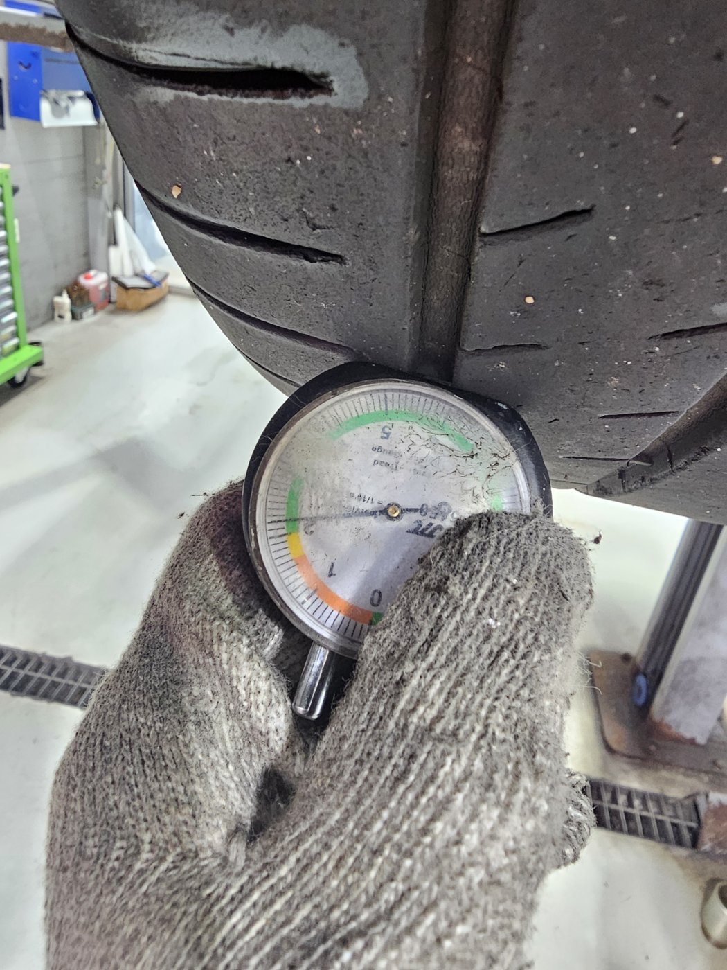 Depth gauge placed in the tire grooves at several points to check remaining tread