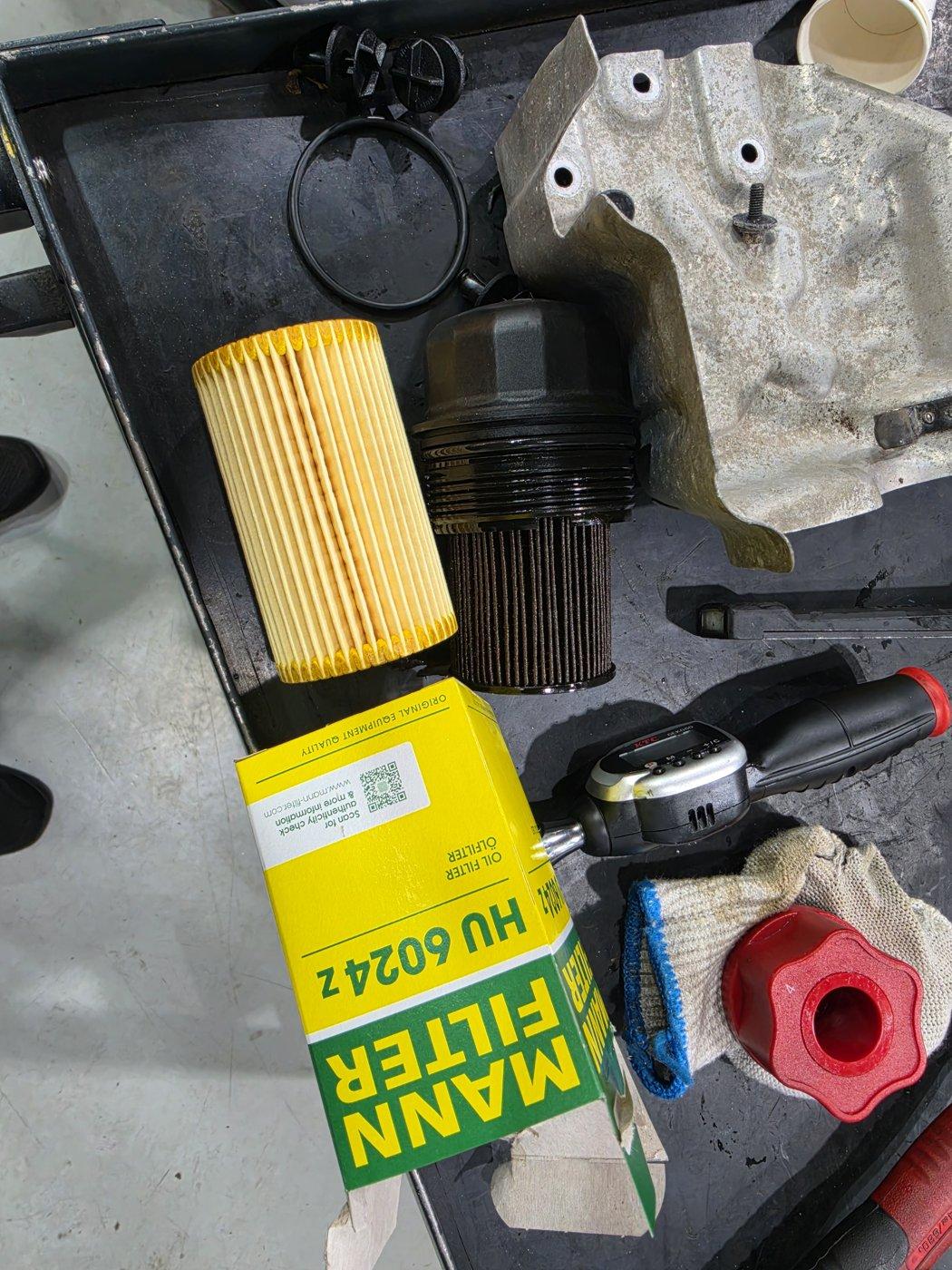 Engine oil filter being replaced