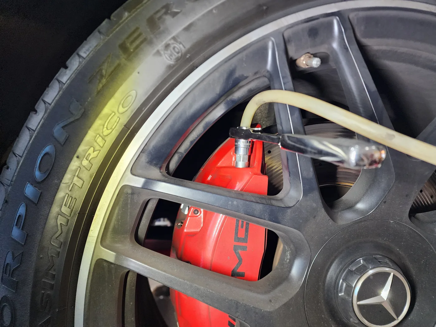 Drain hose connected to a G63 brake caliper for fluid exchange