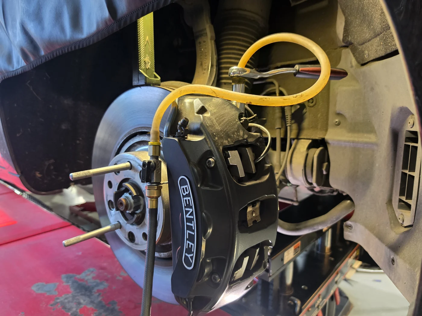 Brake-fluid exchange equipment connected to the caliper bleeders