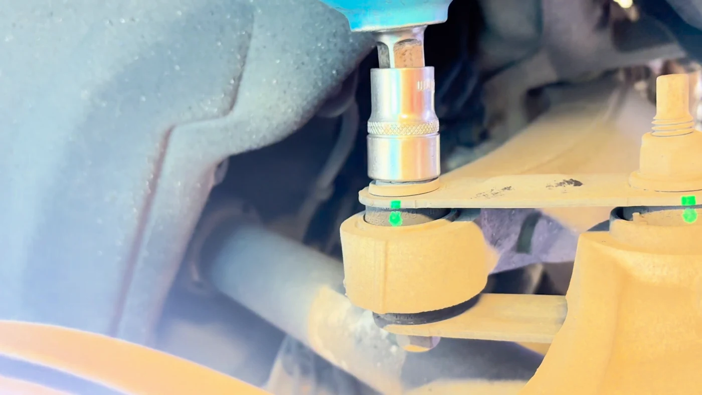 Working at a suspension bushing fastener, captured from the workshop video