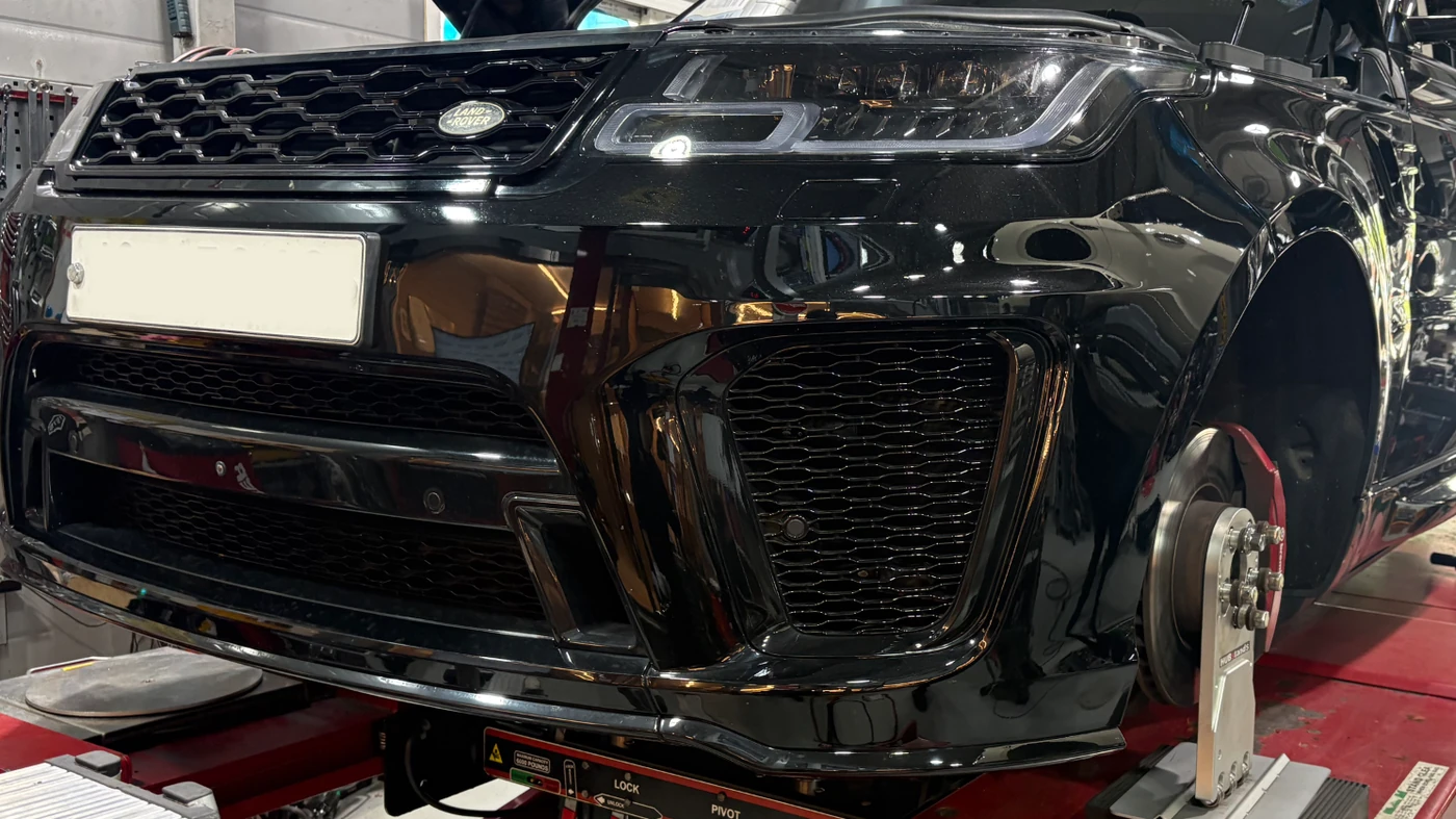 Range Rover Sport during suspension work, with the wheels removed and hubs supported
