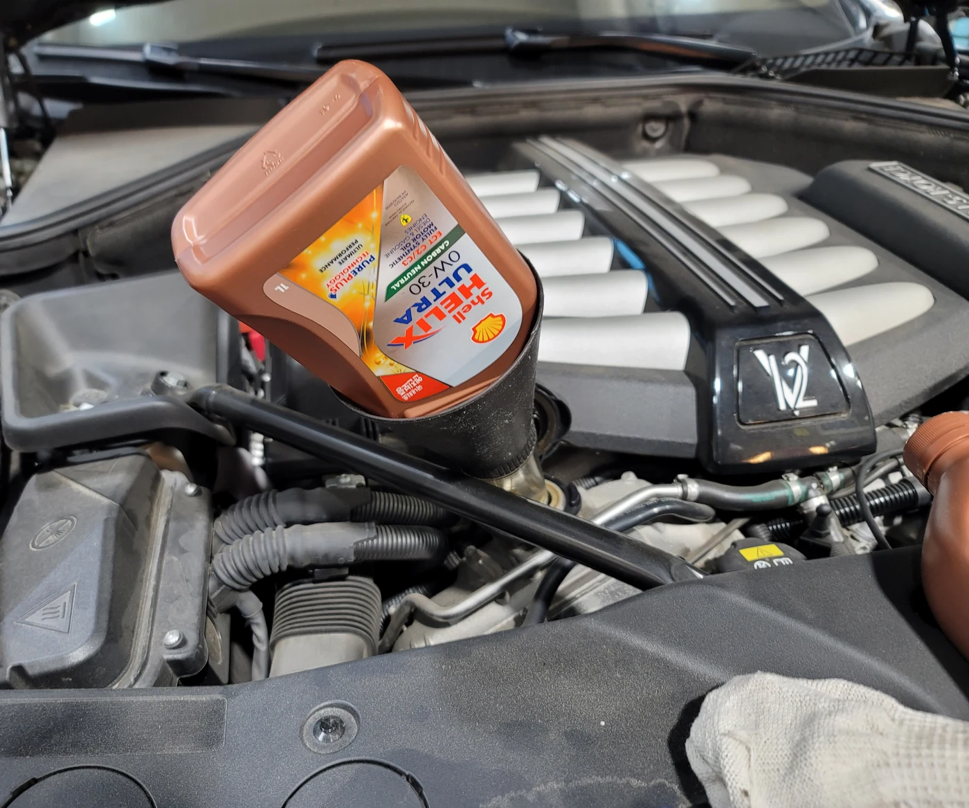 Filling the engine with oil through a funnel